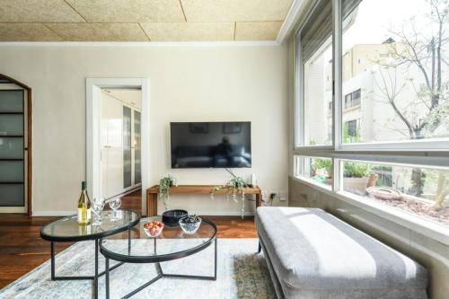 a living room with a couch and a table at Country Style 3BR Apartment 2min from the Beach with Shelter by Sea N Rent in Tel Aviv