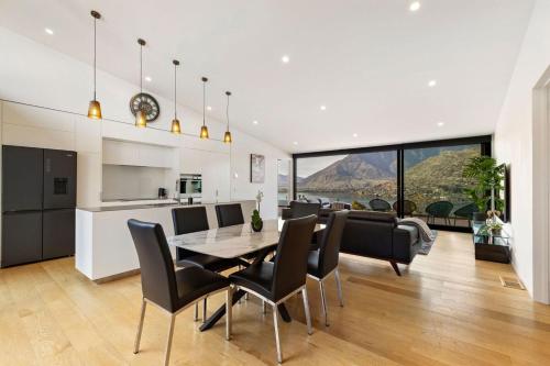 a kitchen and dining room with a table and chairs at Lakevista Retreat - Hot Tub - Spa Pool in Queenstown