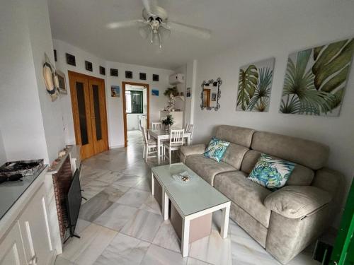 a living room with a couch and a table at La Laguna del Portil in El Portil