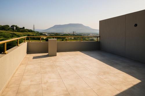 a balcony with a view of a mountain at Vista Bliss 3BHK Villa With Private Pool in Igatpuri