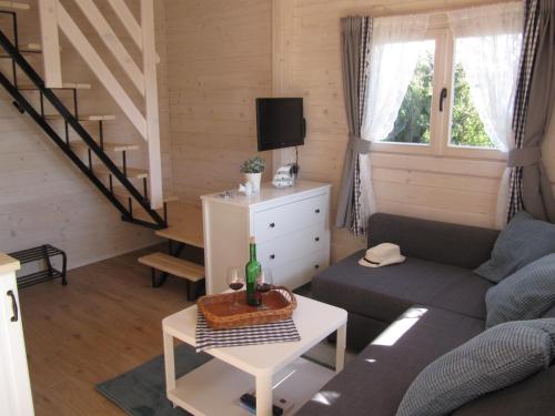 a living room with a couch and a table at Domki I Pokoje Gościnne Marika in Bobolin