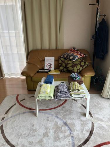 a living room with a coffee table and a couch at 日本家庭風一軒家 いずみ in Sendai