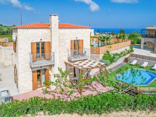 an aerial view of a house with a swimming pool at Villa Erato Klio in Kiriánna