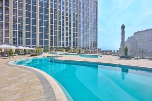 a large swimming pool in front of a tall building at Londoner Grand, a Luxury Collection Hotel, Macau in Macau