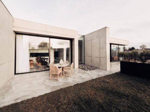 a white house with a table and chairs at Cozy Villa in Dalhem Ardennes with Private Garden in Dalhem