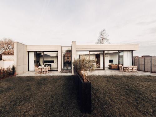 a house with glass doors on a yard at Cozy Villa in Dalhem Ardennes with Private Garden in Dalhem