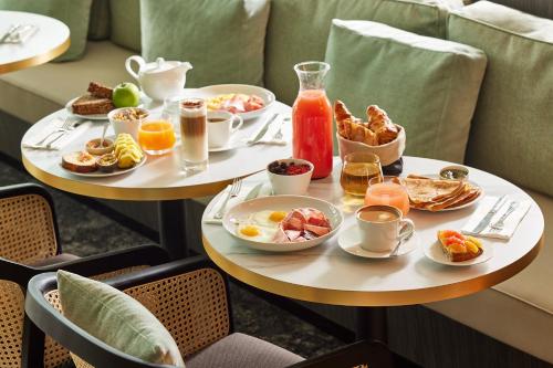two plates of breakfast foods on a table at Domaine du Liziec Vannes - MGallery Collection in Vannes