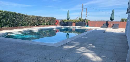 a swimming pool in the middle of a patio at Casa São Domingos in Lousada