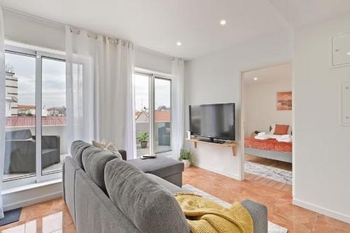 a living room with a couch and a flat screen tv at Apartamento Ponte D Luís in Vila Nova de Gaia
