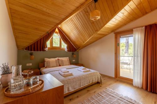 a bedroom with a bed and a large window at Ida Trio in Edremit