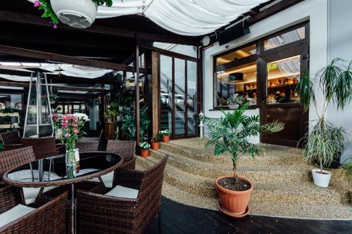 a patio with plants and a table and chairs at Penzion Panda in Turčianske Teplice