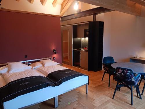 a bedroom with a large bed and a table at Boutique Hotel Bellevue in Interlaken