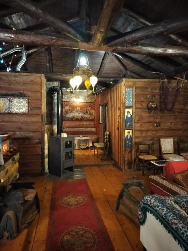 a living room with a stove in a log cabin at Yono's Traditional House in Ano Ravenia