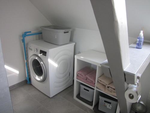a washer and dryer in a laundry room at Ferienwohnung Sabath, 15105 in Leer