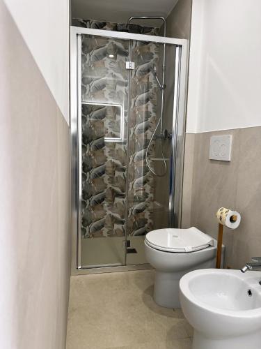 a bathroom with a toilet and a walk in shower at Miria B&B in Castrignano del Capo