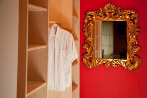 a mirror on a red wall next to a closet at Ferienhaus Alpenpanorama Chalet in Mollenberg