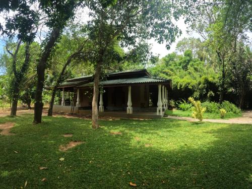 a small house in the middle of a yard at Kirindioya Village Safari Lodge in Tanamalwila