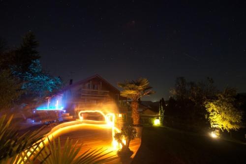 a house lit up at night with lights at Ferienhaus Alpenpanorama Chalet in Mollenberg