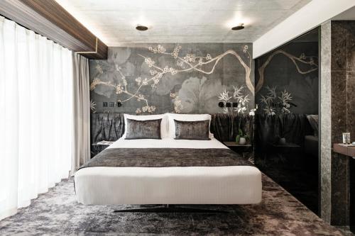 a bedroom with a large bed and a wall mural at Fitch Hotel in St Julian's