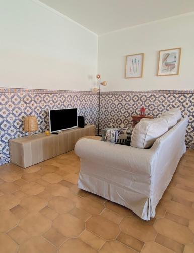 a living room with a couch and a tv at Family Apartment with Balcony, 5 min from the Beach in Santa Cruz