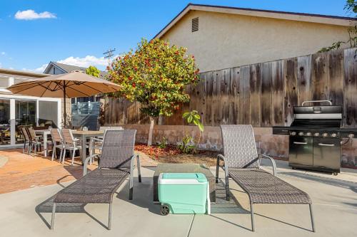 a patio with a table and chairs and a grill at California Dreamin by AvantStay Private Pool Fire Pit Near the Beach in Carlsbad