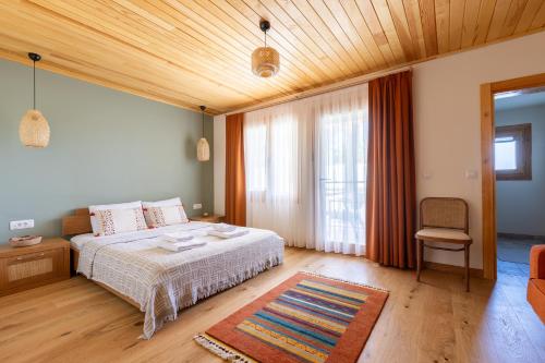 a bedroom with a bed and a wooden ceiling at Ida Trio in Edremit