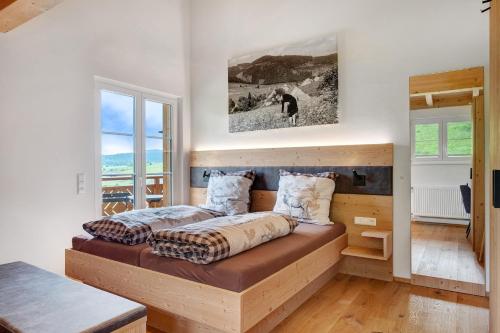 a bedroom with a bed and a large window at Schonzeit Chalet in Bernau im Schwarzwald