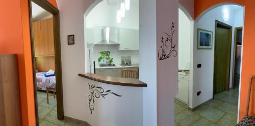 a kitchen with orange walls and a counter in a room at Red Sunset in Nebida