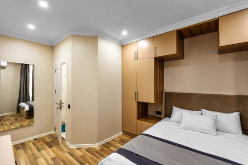 a bedroom with a large bed and a closet at Hillside Boutique Hotel Baku in Baku