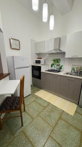 a kitchen with a table and a chair in it at Red Sunset in Nebida