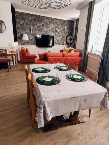 a living room with a table and a couch at Le Familia in Guer