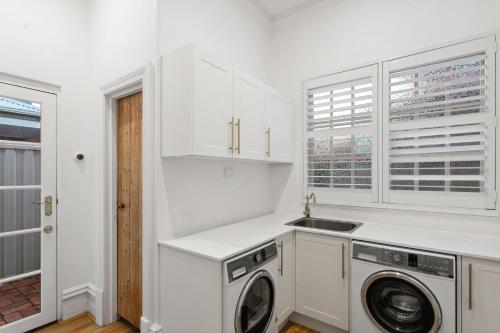 a white kitchen with a washing machine and a sink at Picture Perfect Create timeless treasures in Perth