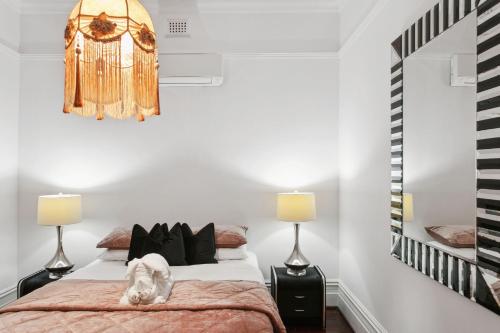 a bedroom with a bed and two lamps at Picture Perfect Create timeless treasures in Perth