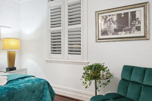 a bedroom with a bed and a window and a chair at Picture Perfect Create timeless treasures in Perth
