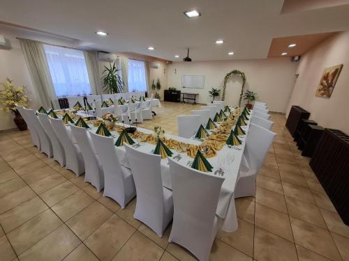 a row of tables and chairs in a banquet hall at Penzion Panda in Turčianske Teplice