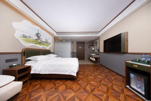 a hotel room with a bed and a flat screen tv at Nost algia S Hotel Tianjin Ancient Culture Street & The Five Avenues 时光漫步S酒店 天津火车站津湾广场店 Free fresh ground coffee,Free laundry service in Tianjin