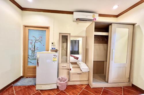 a room with a refrigerator and a bunk bed at Paradise Resort Buriram in Buriram