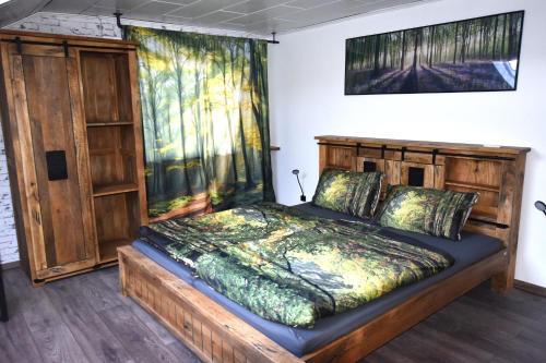 a bedroom with a wooden bed in a room at Ferienwohnung Odenwaldwellness in Wilhelmsfeld