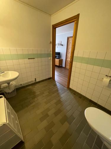 an empty bathroom with two sinks and a doorway at HusHotellHunge AB in Bräcke