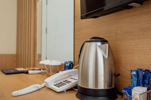 a coffee maker sitting on a desk with a phone at HOTEL TALIA in Herceg-Novi