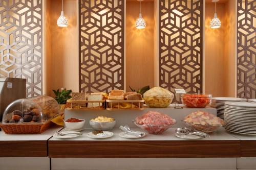 a buffet with bread and other food on a table at Nagarjun Resort - Embrace Tranquility Natures Retreat Beyond the City in Kathmandu
