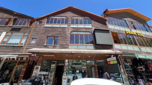a building on a street with a store at Lavera Home Uzungöl in Uzungöl