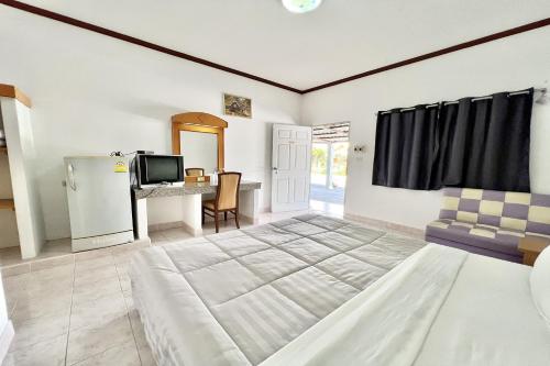 a living room with a television and a table at Paradise Resort Buriram in Buriram