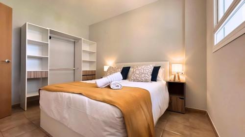a bedroom with a large bed and a window at Mirador de Gema in Torrox Costa
