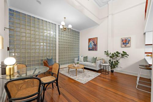 a living room with a glass table and a couch at Ultimate Fremantle Location in Fremantle