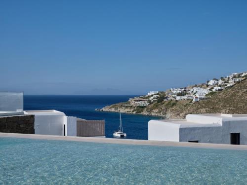 a swimming pool with a view of the ocean at Iria Blue Mykonos in Platis Yialos Mykonos
