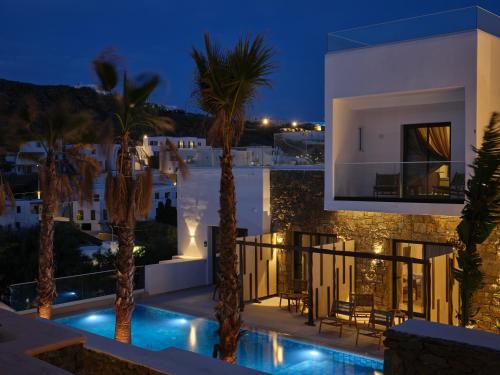 a villa with a swimming pool at night at Iria Blue Mykonos in Platis Yialos Mykonos