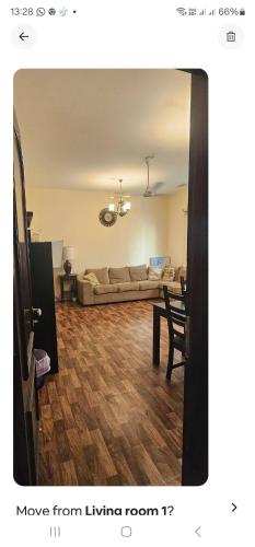 a living room with a couch and a table at UrduEnglishFamilyApartmen in Sharjah