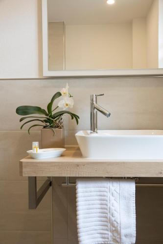 a bathroom with a sink and a mirror at Hotel Rössle in Alpirsbach