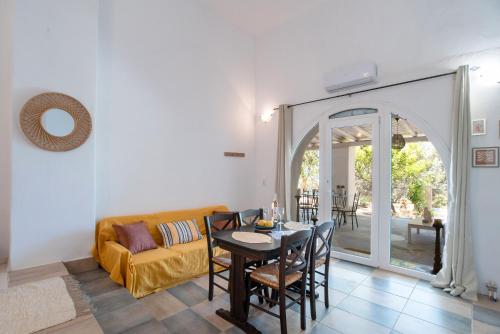 a living room with a table and a couch at Maggano Paros Apartments 2 in Angairiá